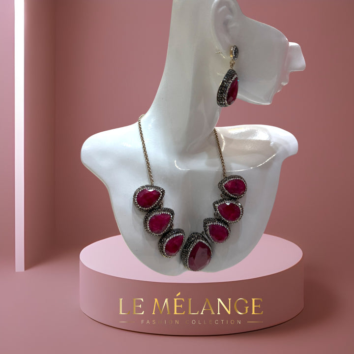 Elegant sterling silver necklace and earrings adorned with rubies and Swarovski crystals