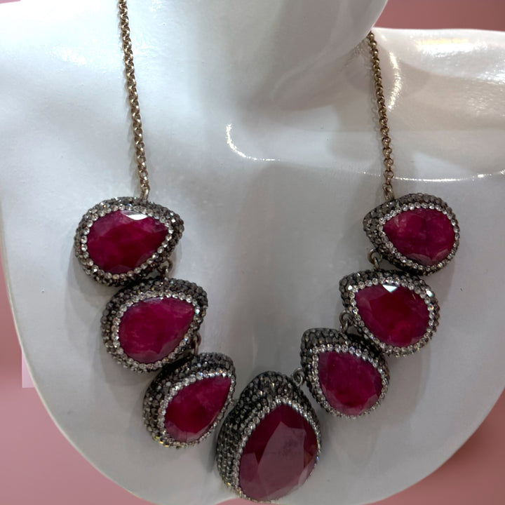 Elegant sterling silver necklace embellished with rubies and Swarovski crystals.