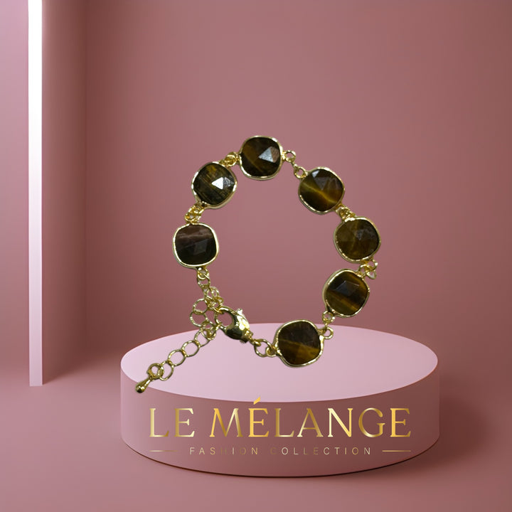 Effortlessly elegant, gold-plated adjustable bangle with tiger's eye stones.