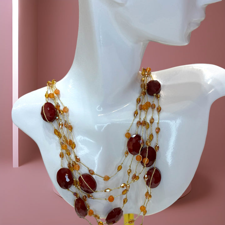 Classic, vibrant red crystals and shimmering gold silk necklace.