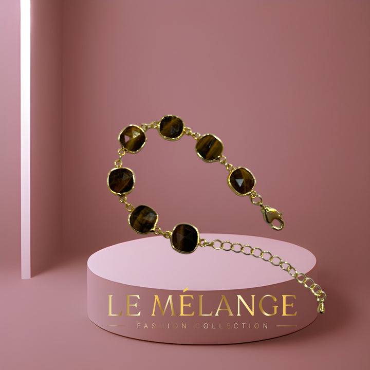 Effortlessly elegant, gold-plated adjustable bangle with tiger's eye stones.