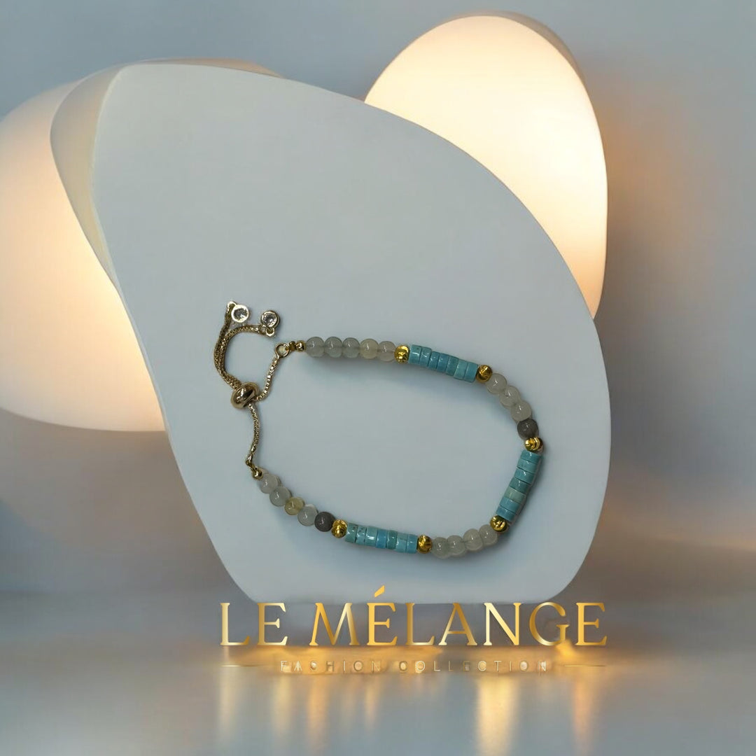 Gold-plated single bangle with an adjustable aquamarine stone and a minimalist design.