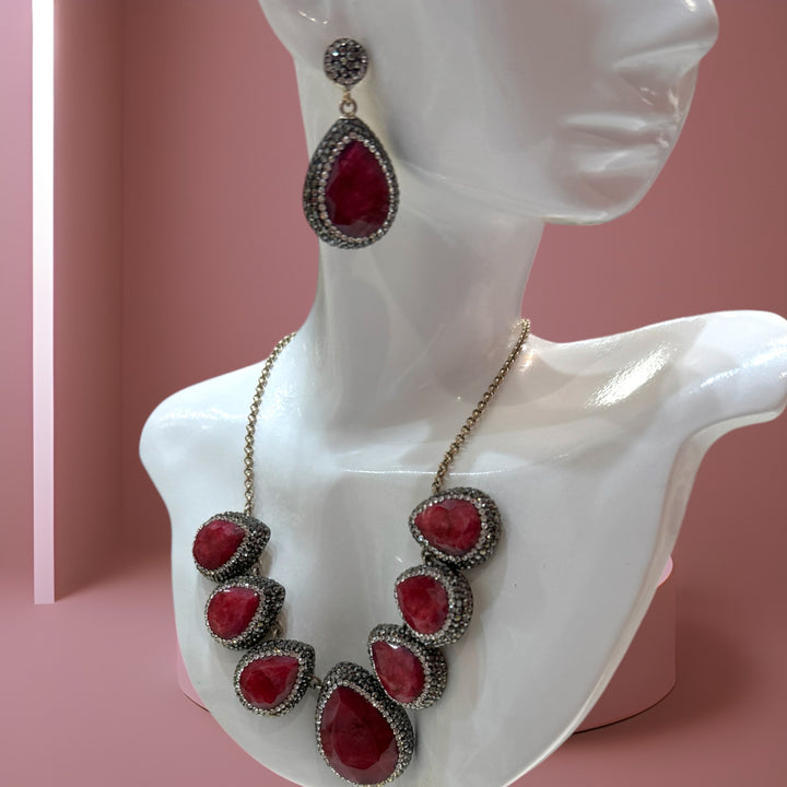 Elegant sterling silver necklace and earrings adorned with rubies and Swarovski crystals