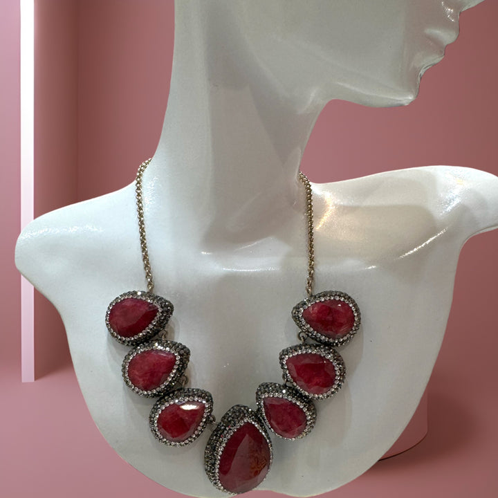 Elegant sterling silver necklace embellished with rubies and Swarovski crystals.