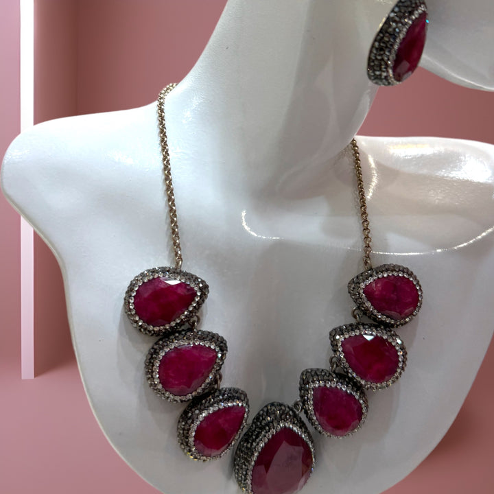 Elegant sterling silver necklace and earrings adorned with rubies and Swarovski crystals